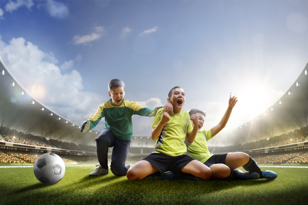 Selebration the victory in children soccer match in grand arenaの写真素材