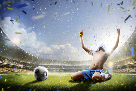 Selebration the victory in children soccer match in grand arenaの写真素材