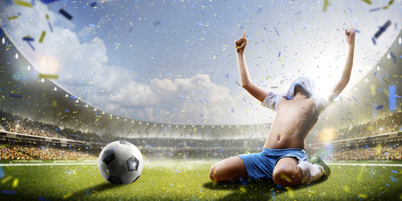 Selebration the victory in children soccer match in grand arenaの写真素材