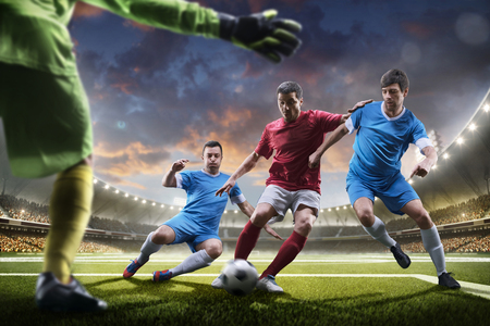 Soccer players in action on the sunset stadium background panoramaの写真素材