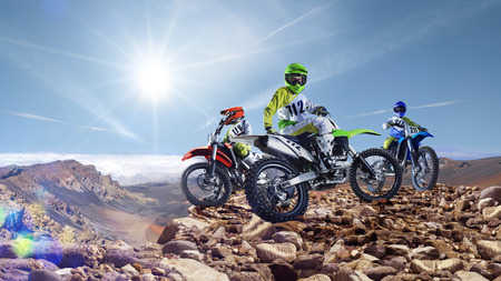 Brave professional dirt bike riders on the top of vulcanの写真素材