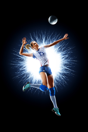 Female professional volleyball player isolated on blackの写真素材