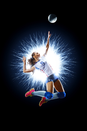 Female professional volleyball player isolated on blackの写真素材