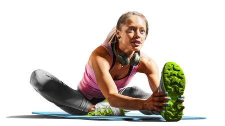 Professional fitness woman working out and stretching isolated on white backgroundの写真素材