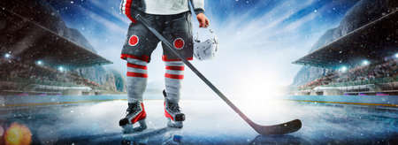 Close up of ice hockey stick on ice rink in position to hit hockey puck.の写真素材