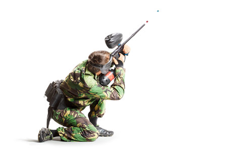 Paintball player in action isolated on white backgroundの写真素材