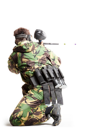 Painball player in action isolated om white bacgroundの写真素材