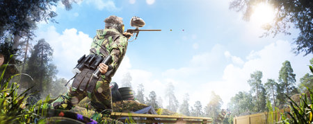 Professional paintball player in action outdoorの写真素材