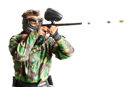 Paintball player in action isolated on white backgroundの写真素材