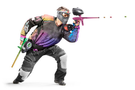 Paintball player in action isolated on white backgroundの写真素材