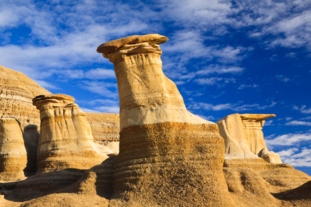 Hoodoos, a geologic formation on a bright day in the badlands near Drumheller, Alberta, Canadaの写真素材