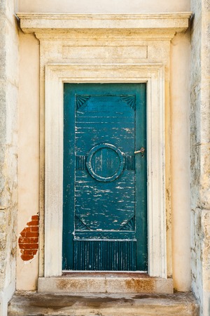 An old worn rustic green door, on a historic building in Europeの写真素材