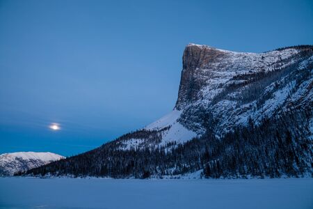 A full moon rising above Ha Ling peak near Canmore, Alberta, Canadaの写真素材