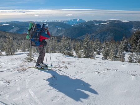 photographer photographing winter panorama in high mountains photographer photographing winter panorama high mountains snow-covered fir-coveredの写真素材
