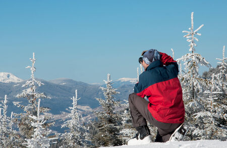 photographer photographing winter panorama in high mountains photographer photographing winter panorama high mountains snow-covered fir-coveredの写真素材