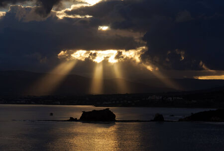 sunset at the Mediterranean sea. slanting rays breaking through the cloudsの写真素材