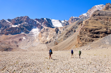 Group of trekkers in the Fany mountain against the blue sky with cloudsの写真素材