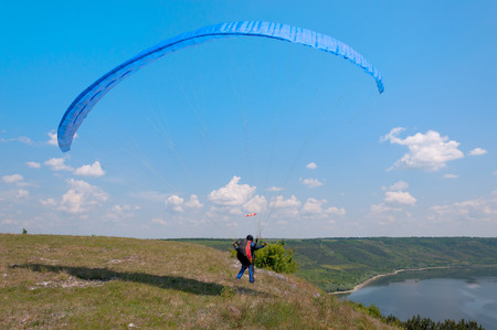 Paraglider prepares to fly over beautiful Bakota reservoir. Ukraineの写真素材