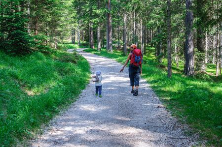 Mother and her daughter hiking in the forest . Travellig adventre and active vacation with children. Dolomites, Italy.の写真素材