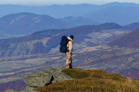 A male tourist walks along mountain autumn rocky trail in the Ukrainian Carpathiansの写真素材