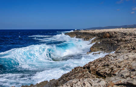 Big waves break on the rocky shore on the mediterranean sea.Cyprusの写真素材