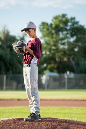 Young pitcher on baseball moundの写真素材