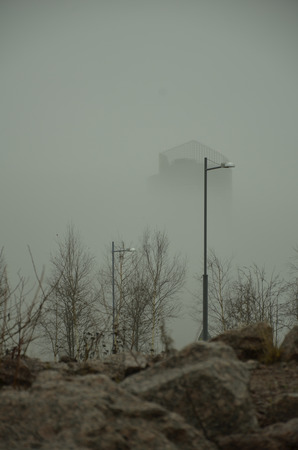 city in the mist, outlines of the buildings looming out of fogの写真素材