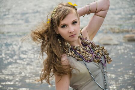 mermaid in sea, gown of silver parachute silk necklace of shells and pearl gold jewelry. Wind storm. An allusion to the Scandinavian and Celtic mythology.の写真素材