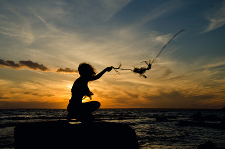 girl on the shore, woman's silhouette on beachの写真素材