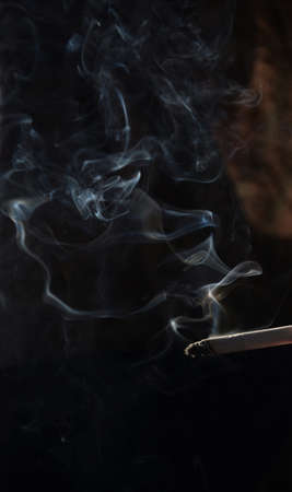 smoking image on a black backgroundの写真素材
