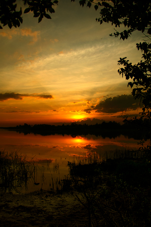 golden nature reserve, sunset view from the shoreの写真素材