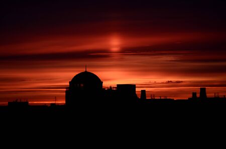 Dome of the building. A silhouette of a roof of a residential house on sunsetの写真素材