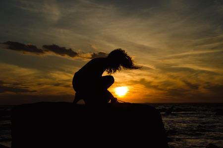 woman's silhouette and sunsetの写真素材