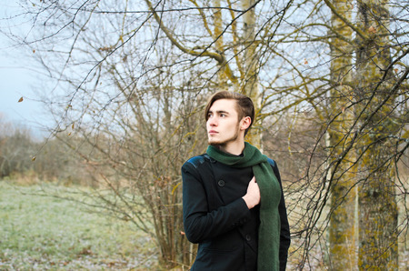 young man walking in autumn Parkの写真素材