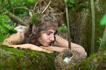 Dryad guarding a bird's nest in the woodsの写真素材