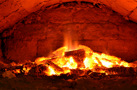 hot flaming wood in the hearth close-up-background imageの写真素材