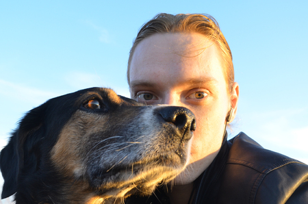 young man and his hunting dog close upの写真素材