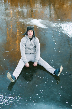 guy in the gray tracksuit sitting on the iceの写真素材