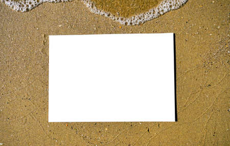 copy space on the wet sand of the beach with sea foamの写真素材