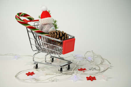 Christmas card vintage Teddy bear in a supermarket cart with a candy caneの写真素材