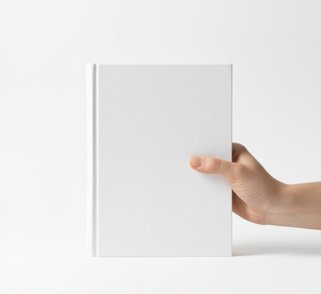 Blank book in hand on white background. Mockup for designの素材
