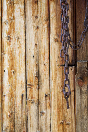 Metal Chain on Old Wooden Planks Background Textureの写真素材