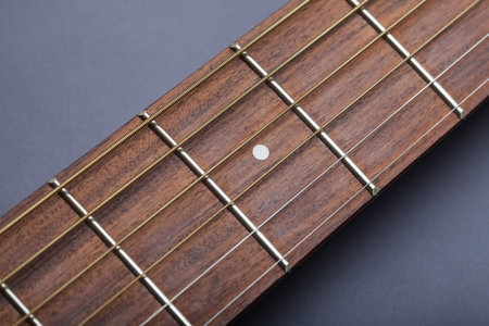 Fretboard on Acoustic Guitar Close-Up on Fifth Fret