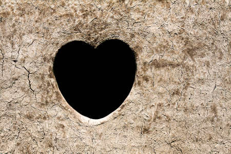 Hearth shape on dirt wallの写真素材