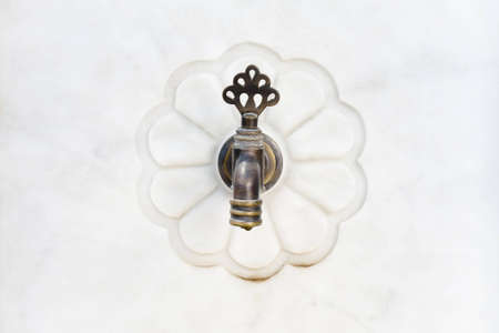 Vintage turkish style faucet on marble wallの写真素材