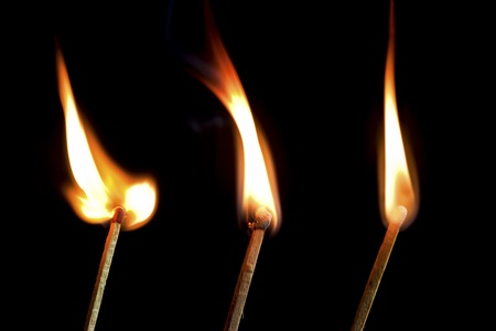 Burning three match sticksの写真素材
