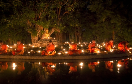 CHIANG MAI THAILAND - AUGUST 2 : Asarnha Puja Day is the third most important Buddhist holiday. Buddhist monk fire candles to the Buddha. Aug 2,2012 in Phan Tao Temple, Chiangmai, Thailand.のeditorial素材