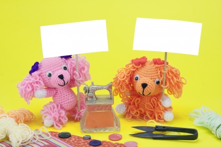 dogs knitting doll with sewing machine holding placard の写真素材