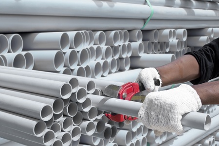 Worker cut pvc pipe in construction siteの写真素材