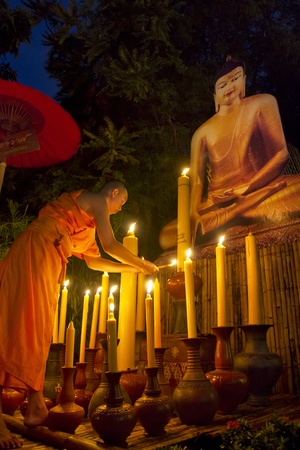 CHIANG MAI THAILAND - July 22 : Asalha Puja Day is the important incidents Buddhist day. Buddhist monk fire candles to the Buddha. July 22, 2013 in Phan Tao Temple, Chiangmai, Thailand.のeditorial素材